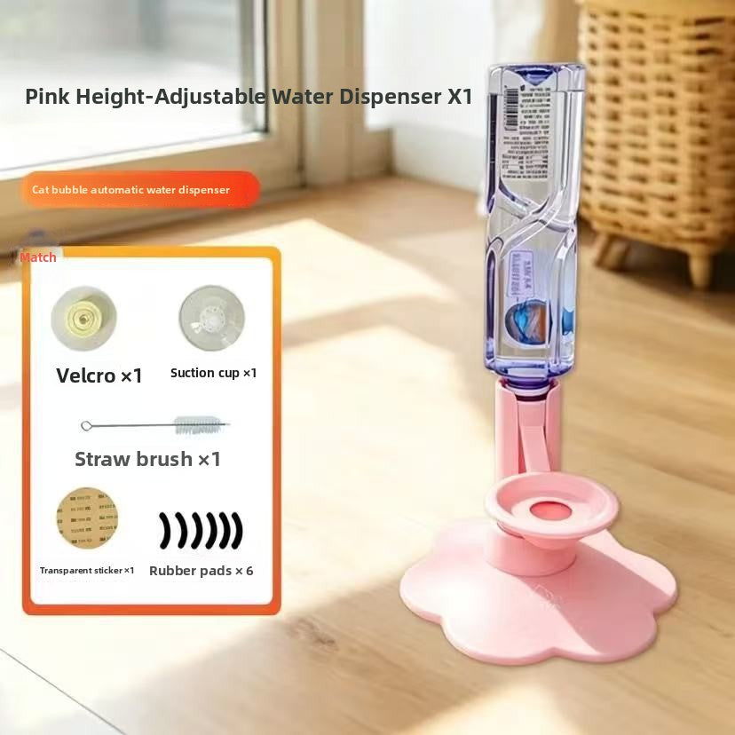 Pink adjustable pet water dispenser with a flower-shaped base, shown on a wooden floor in a bright room. The dispenser has a clear bottle attached and includes an inset graphic listing included accessories: Velcro, suction cup, straw brush, transparent sticker, rubber pads, and a cat bubble automatic water dispenser.
