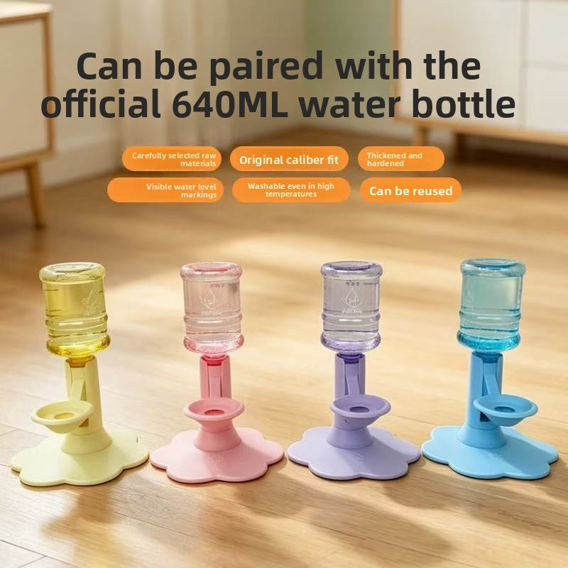 Four pet water bottles in pastel yellow, pink, lavender, and blue are lined up on a wooden floor, with promotional text above stating they can be paired with an official 640ML water bottle.
