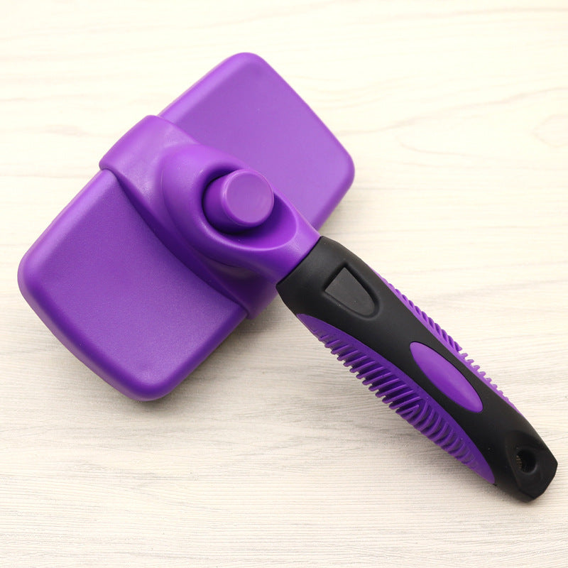 Purple pet grooming brush on a light wooden surface
