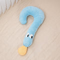Blue plush toy shaped like a question mark on a beige surface