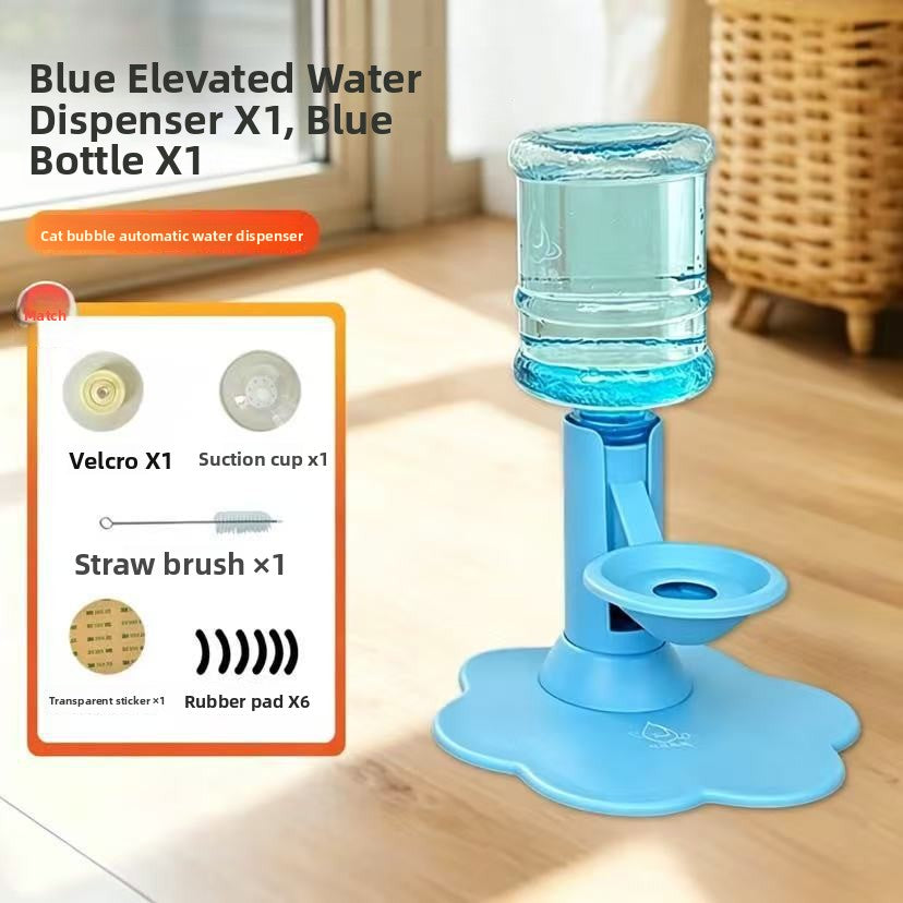 Blue elevated water dispenser with a clear water bottle and suction cup base, shown on a wooden floor in a home setting. An inset graphic on the left lists included accessories: Velcro, suction cup, straw brush, and rubber pads.
