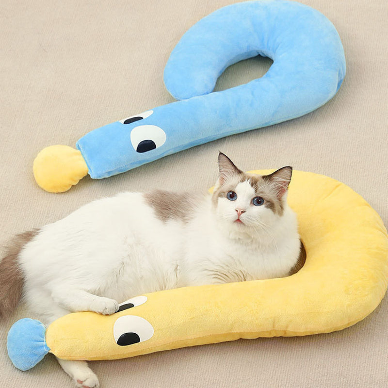 Cat lying on a yellow and blue pet bed shaped like a snake.