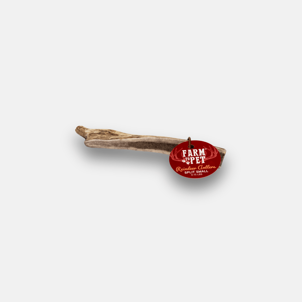 A rustic wooden twig charm with a small oval red tag attached. The tag features white text that reads 'FARM PET' with 'Rustic Collection' and 'SANTA ANA, FL.