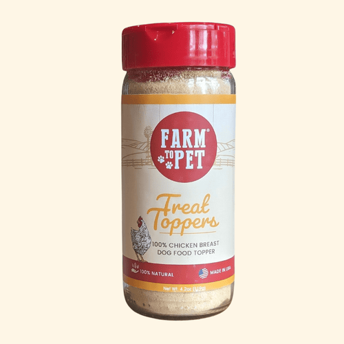 A bottle of Farm to Pet Treat Toppers for dogs, featuring a red cap and a white label with red and yellow text, set against a solid cream background.