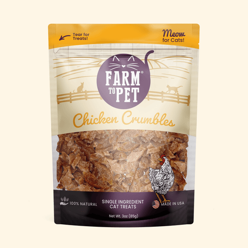 A 3 oz stand-up pouch of Farm to Pet Chicken Crumbles single ingredient cat treats, featuring a clear window showing the textured brown treats inside, set against a solid cream background.
