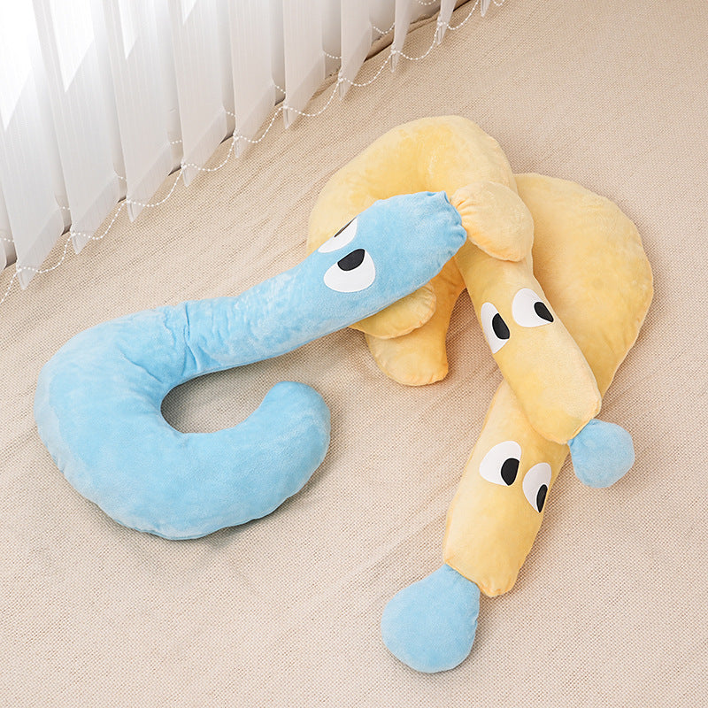 Two plush snake toys, one blue and one yellow, on a beige surface.