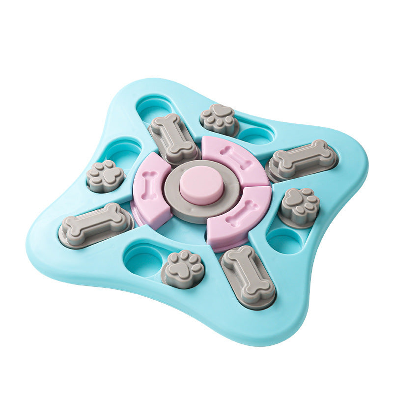 A star-shaped plastic dog puzzle toy in light blue, featuring pink and gray rotating pieces, bone and paw print shapes, on a solid white background.
