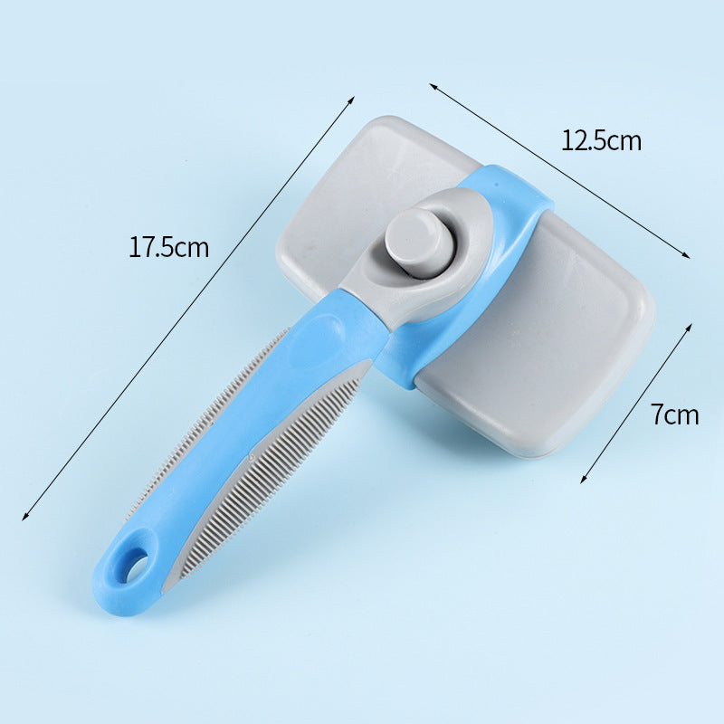 A pet grooming brush with a light blue handle, gray bristles, and a gray rectangular cleaning pad, shown on a light blue background with dimension lines and labels indicating 17.5cm length, 12.