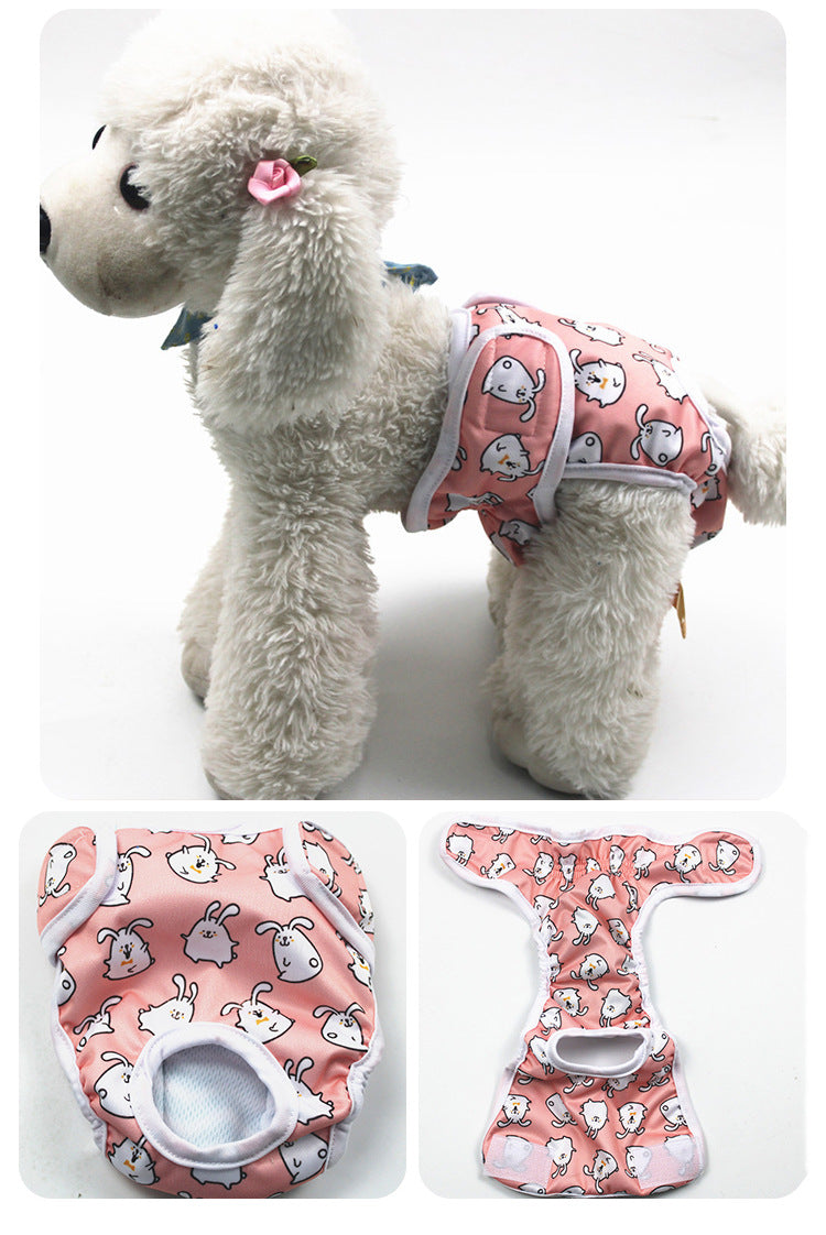 Gray plush dog toy with a pink patterned diaper on a white background