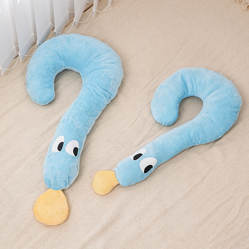 Two blue snake-shaped pillows with eyes and a yellow nose on a beige surface.